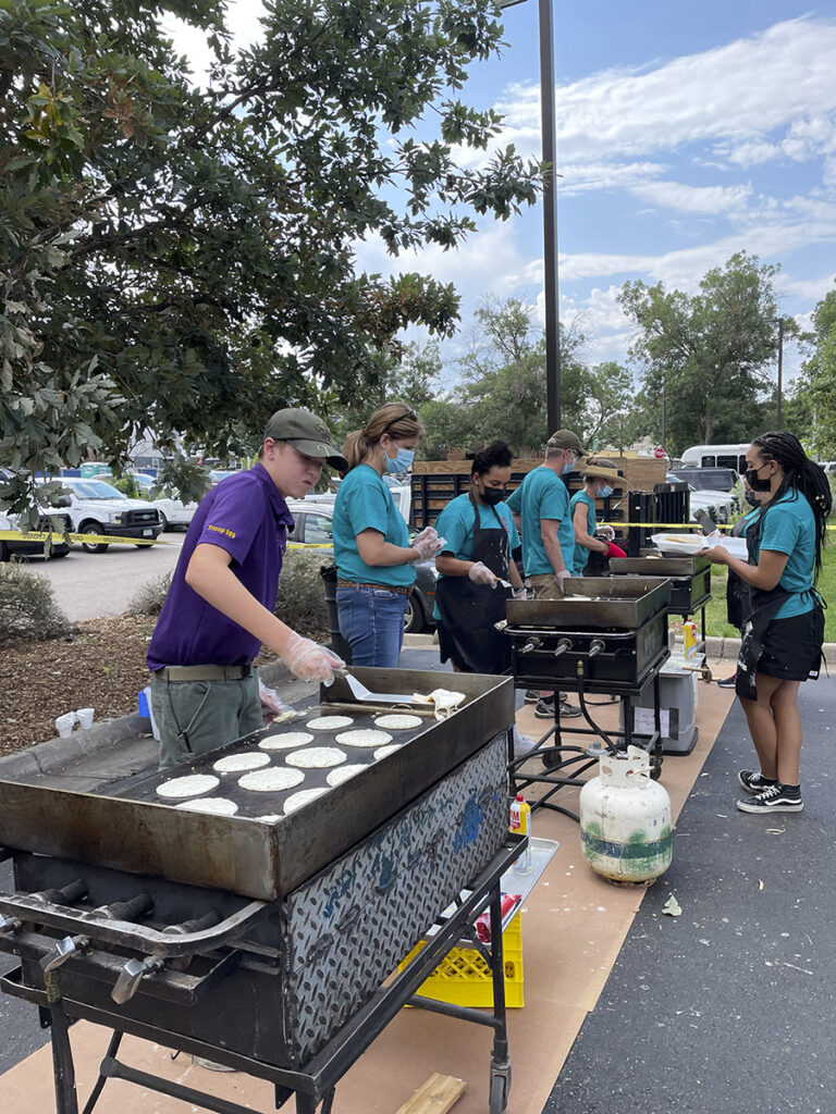 Volunteers flip pancakes on the grills at the Pancake Breakfast.